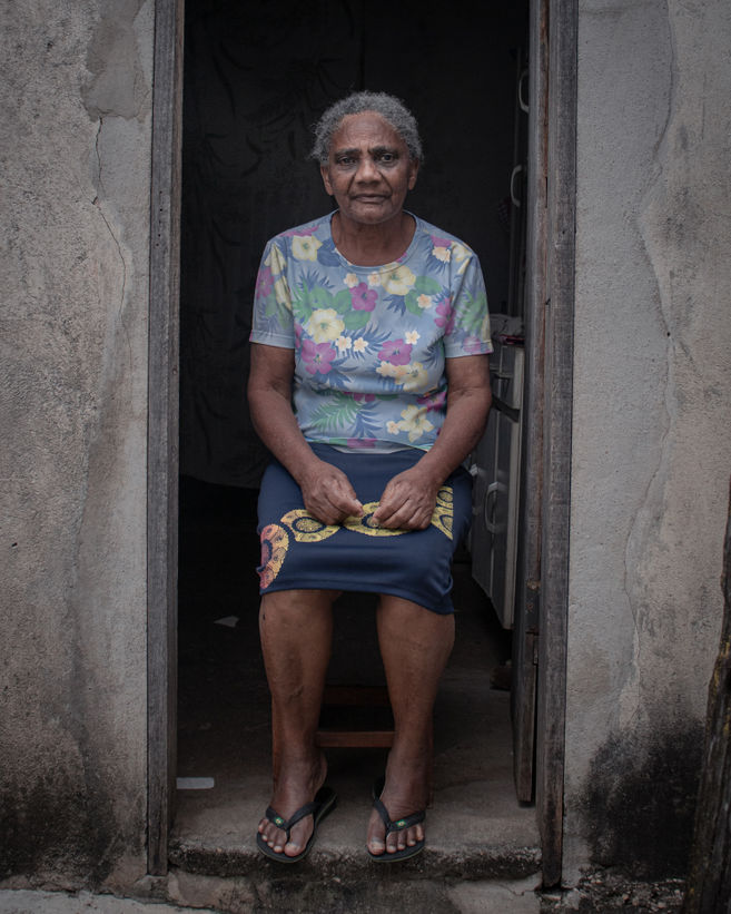 Raimunda, benzedeira, sits at the backdoor of her house in Diamantina.