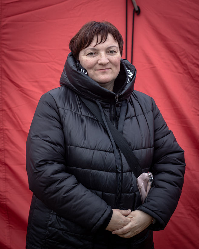 Olga Bilous, entrepreneur and former owner of an eyeglass stand in a Bazar in Zaporizhzhia, poses in front of a sleeping tent in Vyšné Nemecké.