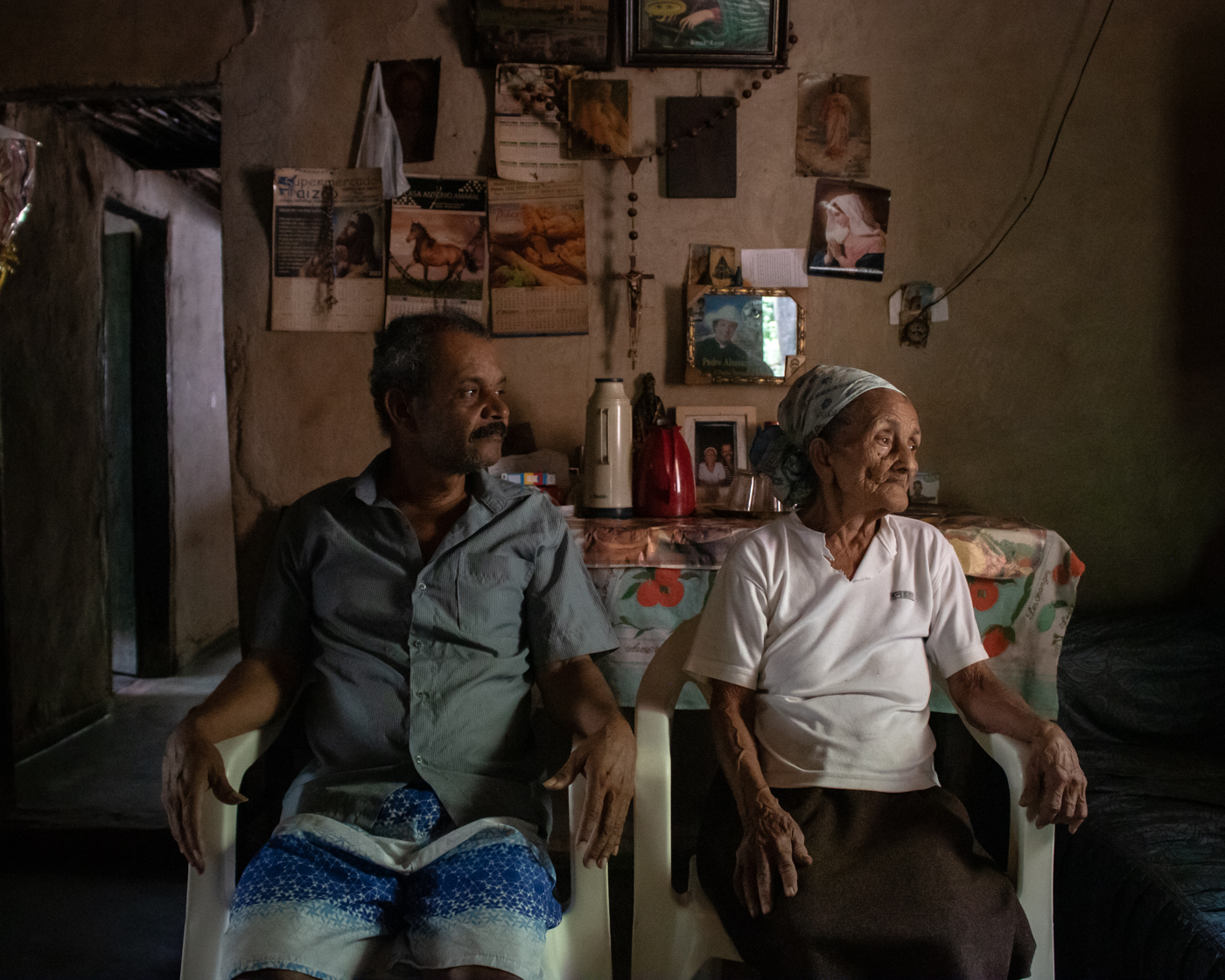 Andrezinho (left) sits next to his mother, Maria Teixeira, from whom he has learned the trade of benzer.