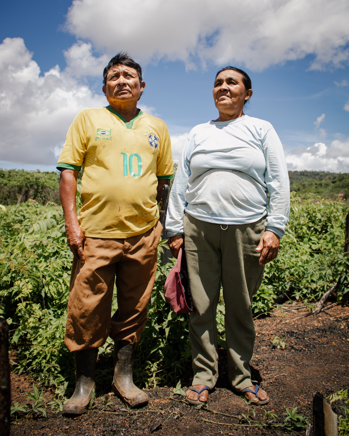 Telma Macuxi and her husband pose in front of their field in the Willimon community.