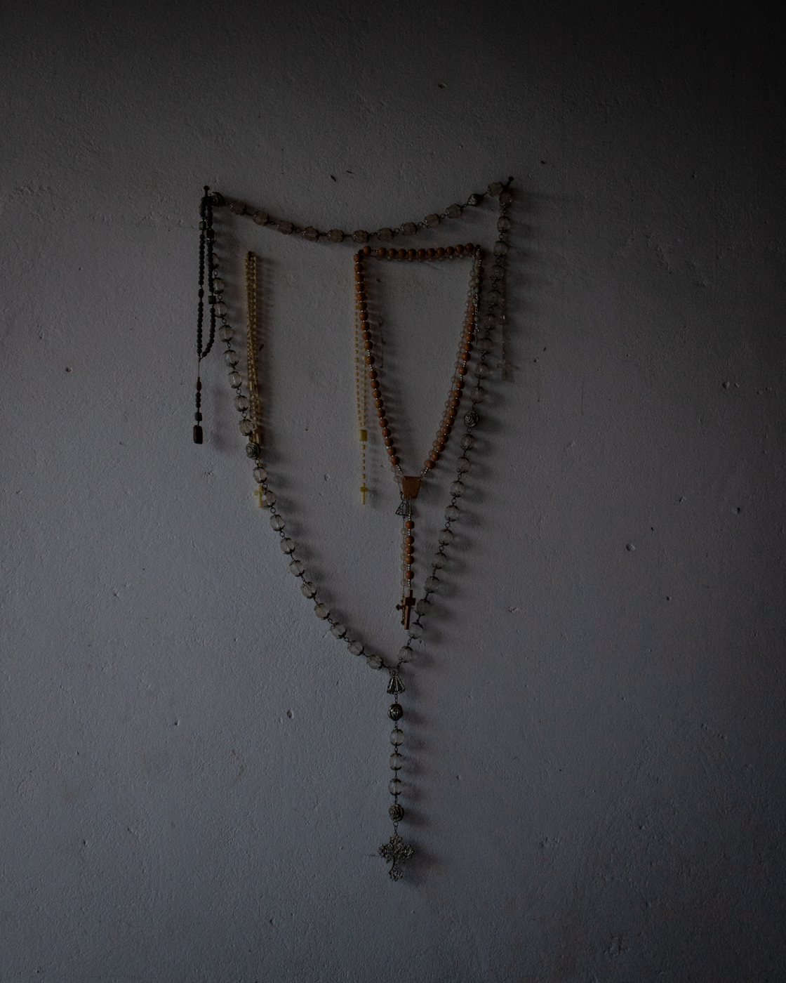 Rosaries hanging in the wall of Generina's home.