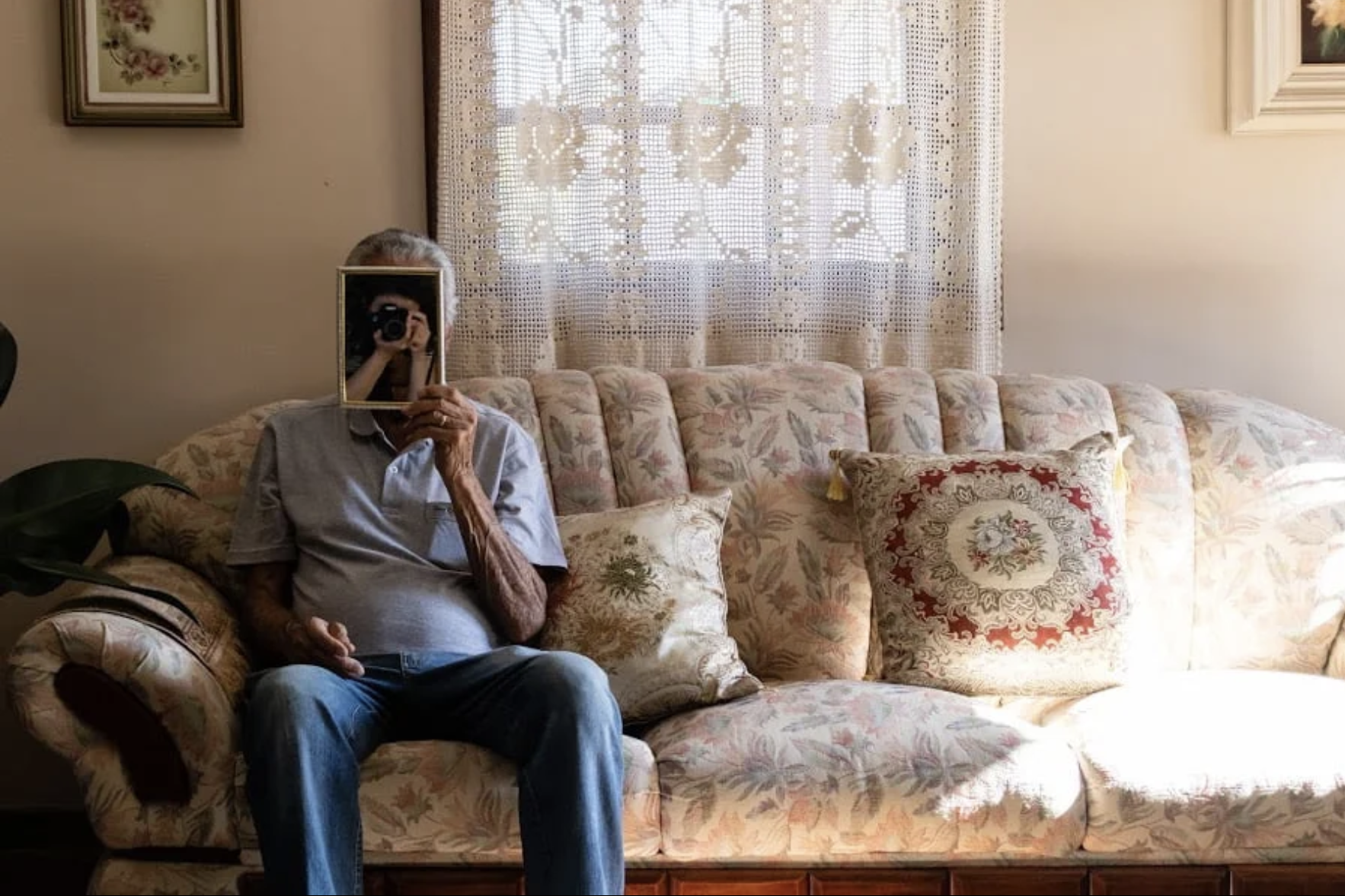 Edivaldo, my grandfather on my mother’s side, sits in his living room and holds a mirror where my image is reflected.