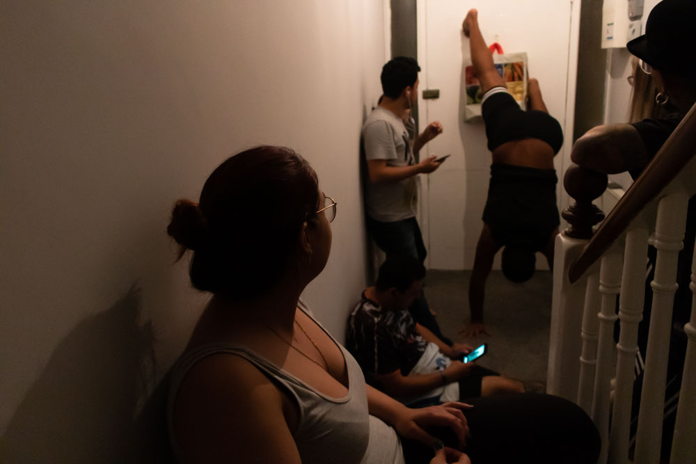 Some of the residents got together in the entrance hall after dinner as Jonathan (center) tried to replicate a trending challenge from TikTok, where he took his shirt off and put it back on while doing a handstand against the door. From left to right: Beatriz, Pedro, Felipe, Jonathan and Everton.